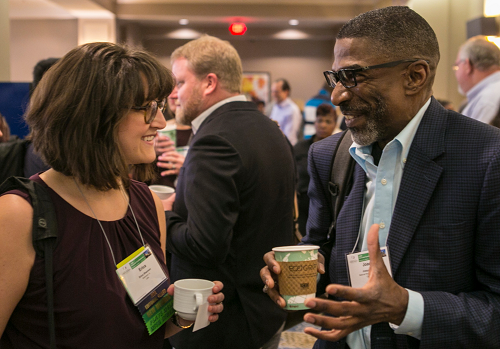 Two Conference attendees talking over coffee